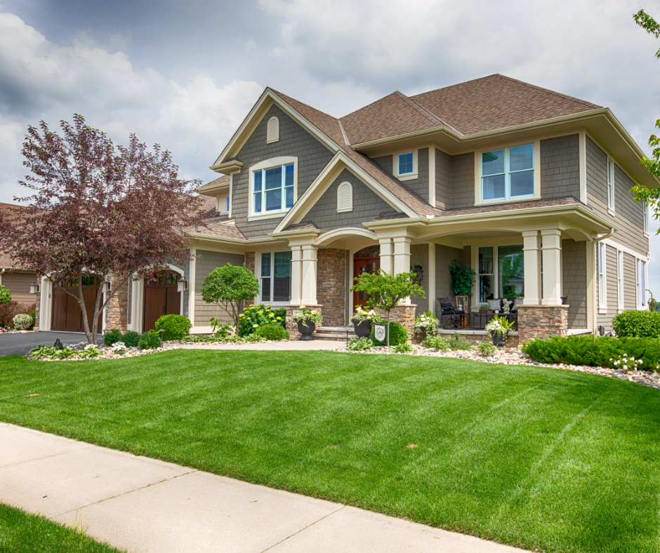 Spring cleanup service by J&A Landscaping featuring a freshly mowed lawn, pruned trees, and tidy front yard ready for the season.
